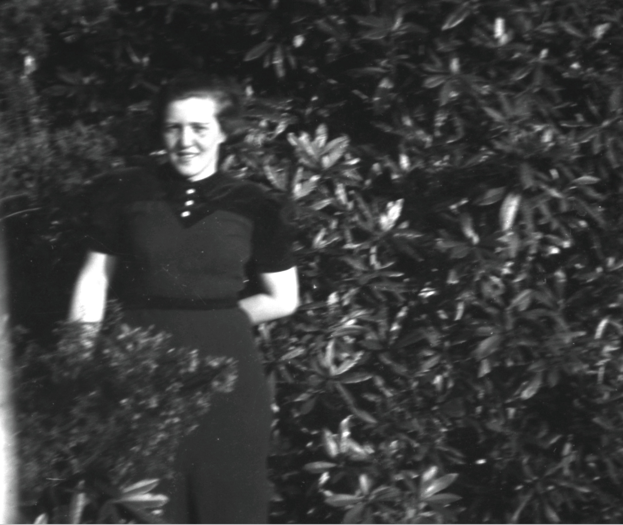 Girl standing by bush.jpg